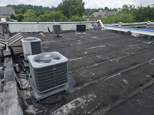 Cleaned modified bitumen roof field at 2105 Mt Vernon Ave after power washing, with rooftop HVAC condensing units in place