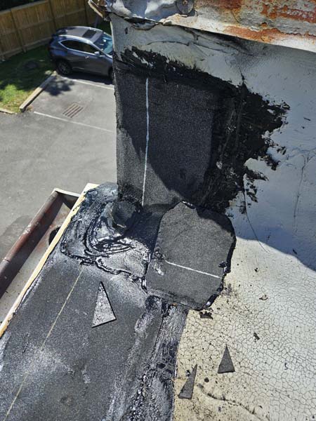 Rebuilt base flashing at a wall transition on the roof at 2330 Columbia Pike, with new membrane and reinforced mastic detailing