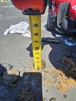 Roof core sample at 150 E Wolfe St exposing two existing roof layers over fiberboard insulation and a concrete deck