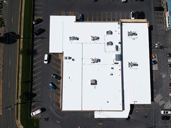 Aerial drone view of the completed Elevate UltraPly 60-mil TPO roofs at the 150 E Wolfe St shopping center in Harrisonburg, Virginia