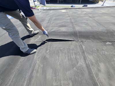 Open and separating modified bitumen membrane seam on Roof 1 at 150 E Wolfe St before tear-off