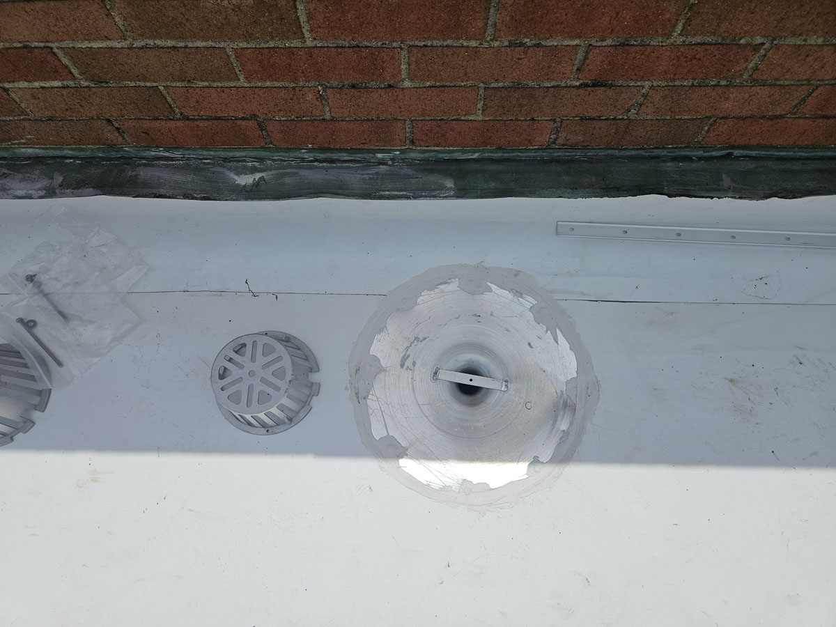 Rebuilt roof drain with new clamping ring flashed into the Elevate TPO membrane at 150 E Wolfe St
