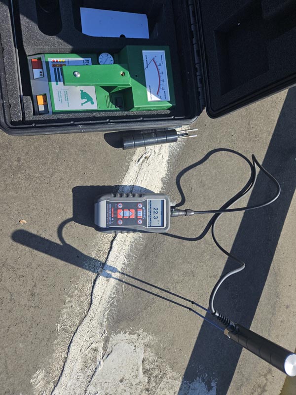 Tramex moisture meter recording a non-destructive moisture reading on the existing roof assembly at 150 E Wolfe St