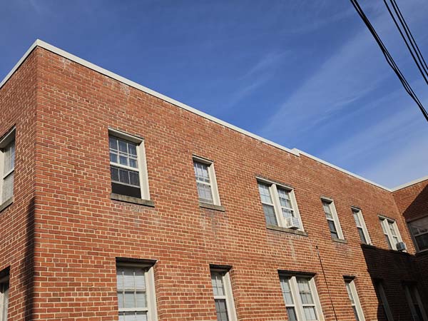 Completed parapet coping running the length of the brick elevation at 2801 Pennsylvania Ave SE