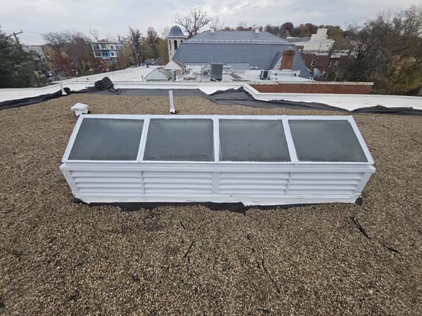 Restored skylight refinished in white with its curb re-flashed into the new roof at 2801 Pennsylvania Ave SE