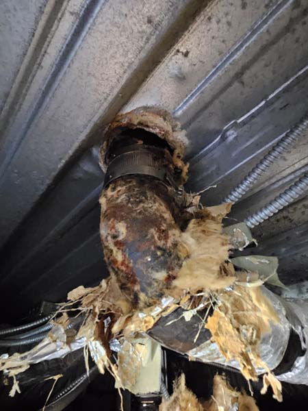 Deteriorated commercial roof drain at 633 Pennsylvania Ave NW before drainage repairs