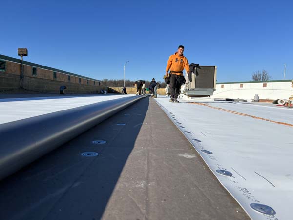 Elevate UltraPly 60-mil TPO membrane being installed over new polyisocyanurate insulation at 7171 New Market Ct