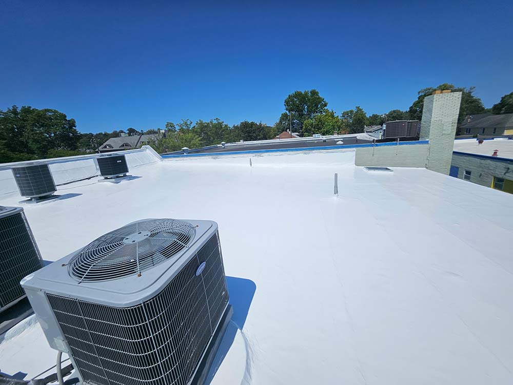 White silicone-coated flat roof with rooftop condensing units at 2105 Mt Vernon Ave, Alexandria, VA