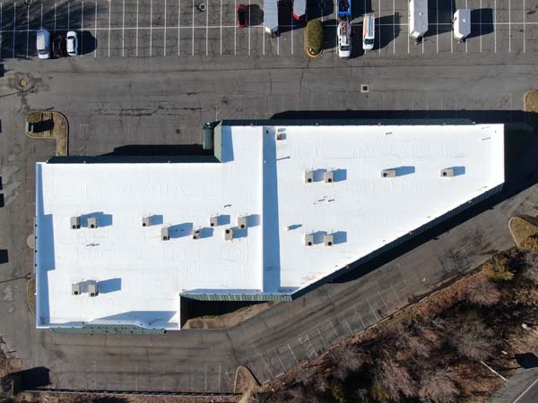 Overhead drone view of the completed white TPO roof on the retail center at 7171 New Market Court, Manassas, VA